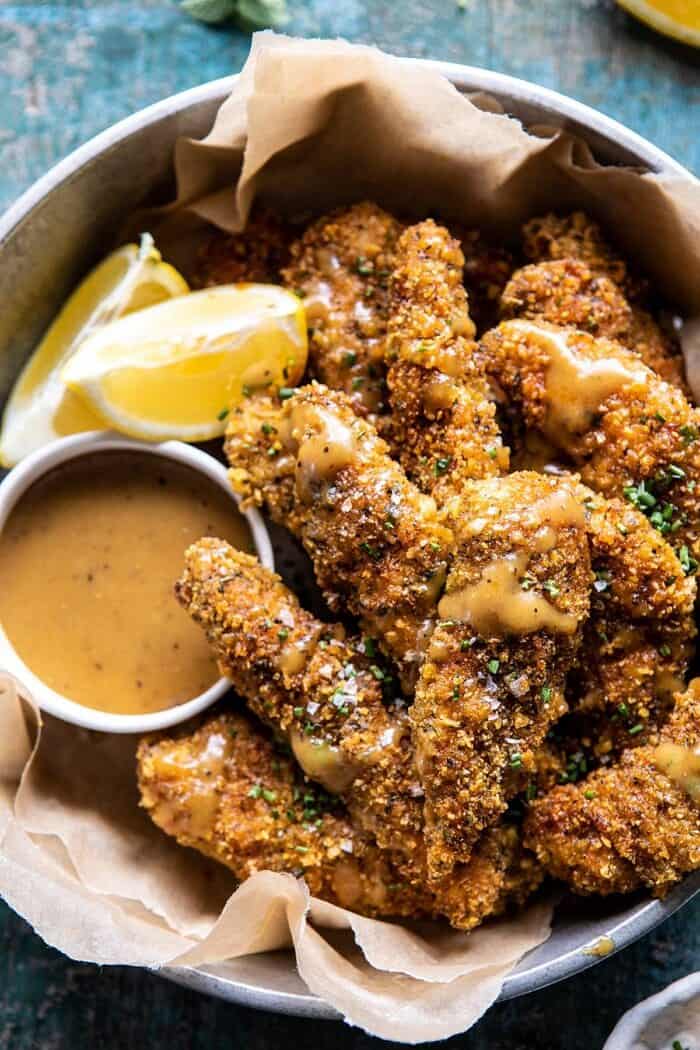 Baked Black Pepper Ranch Chicken Fingers with Honey Mustard | halfbakedharvest.com #chicken #easyrecipes #dinner #chickenfingers overhead close up photo of Baked Black Pepper Ranch Chicken Fingers with Honey Mustard
