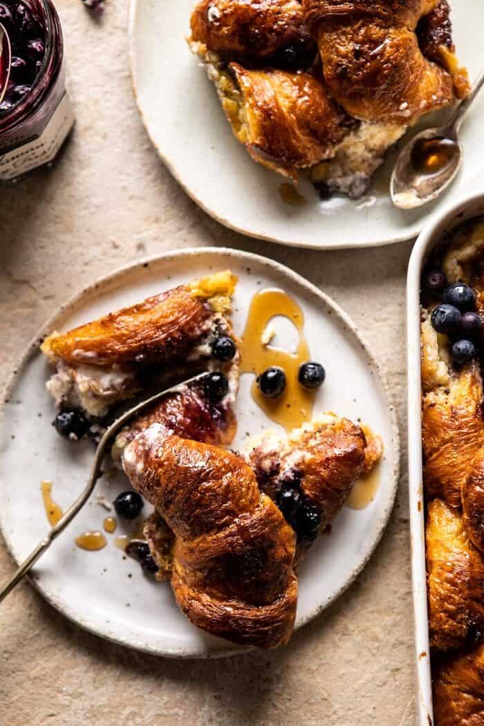 Berry and Cream Cheese Croissant French Toast Bake | halfbakedharvest.com #frenchtoast #brunch #easyrecipes #springrecipes #easter overhead of Berry and Cream Cheese Croissant French Toast on plates