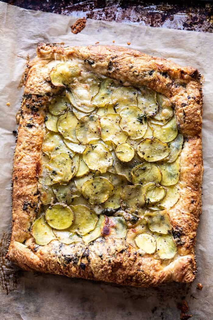 Cheesy Potato Chive Galette | halfbakedharvest.com #potato #cheese #easyrecipes #appetizer #Easter #spring overhead photo of Cheesy Potato Chive Galette after baking on baking sheet