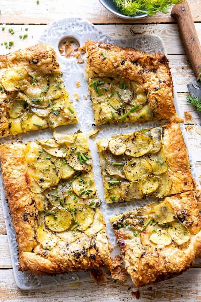Cheesy Potato Chive Galette | halfbakedharvest.com #potato #cheese #easyrecipes #appetizer #Easter #spring overhead photo of Cheesy Potato Chive Galette with slices cut