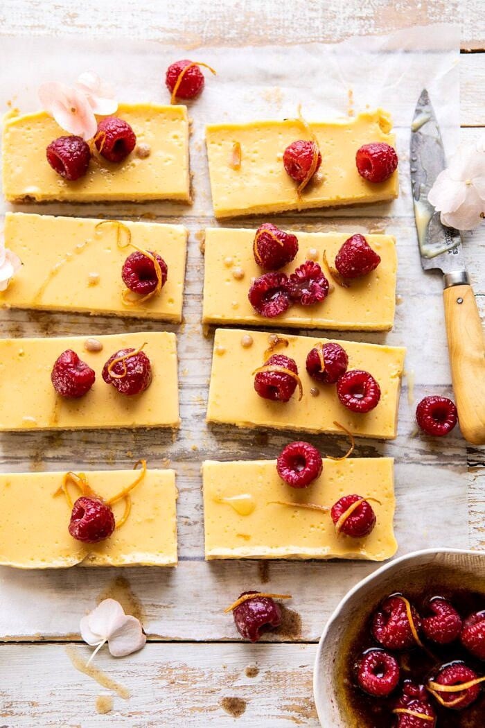 Creamy Lemon Bars with Browned Butter Raspberries | halfbakedharvest.com #lemon #brownbutter #spring #summer #easter #mothersday #brunch #dessert overhead photo of Creamy Lemon Bars with Browned Butter Raspberries | halfbakedharvest.com #lemon #brownbutter #spring #summer #easter #mothersday #brunch #dessert