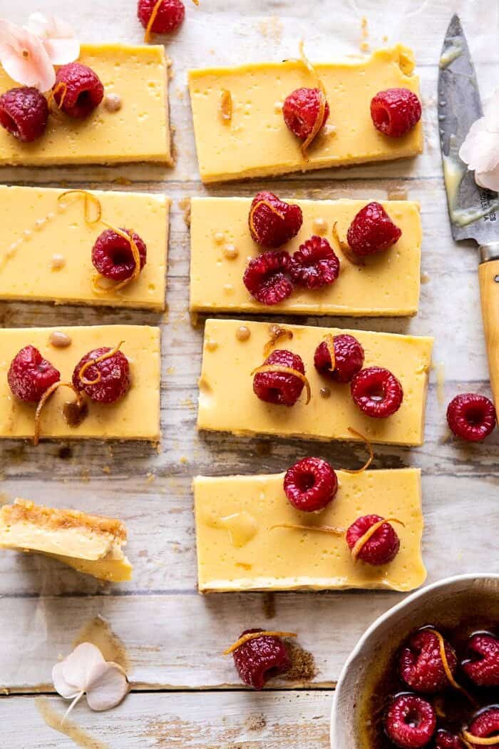 Creamy Lemon Bars with Browned Butter Raspberries | halfbakedharvest.com #lemon #brownbutter #spring #summer #easter #mothersday #brunch #dessert close up photo of Creamy Lemon Bars with Browned Butter Raspberries