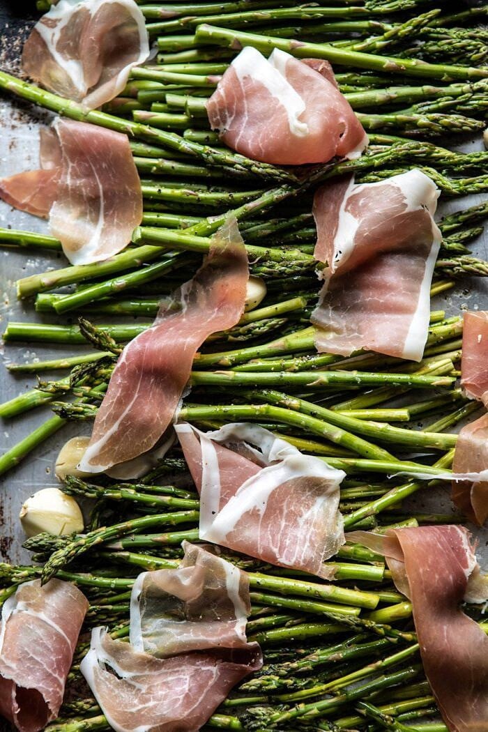 Crispy Prosciutto, Asparagus, and Brie Toast | halfbakedharvest.com #easyrecipes #appetizers #brie #mothersday #spring #summer Prosciutto and Asparagus on baking sheet before roasting