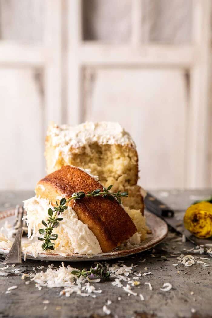 Lemon Coconut Naked Cake with Whipped Vanilla Buttercream | halfbakedharvest.com #coconutcake #springrecipes #easter #cake #layercake Lemon Coconut Naked Cake piece on plate