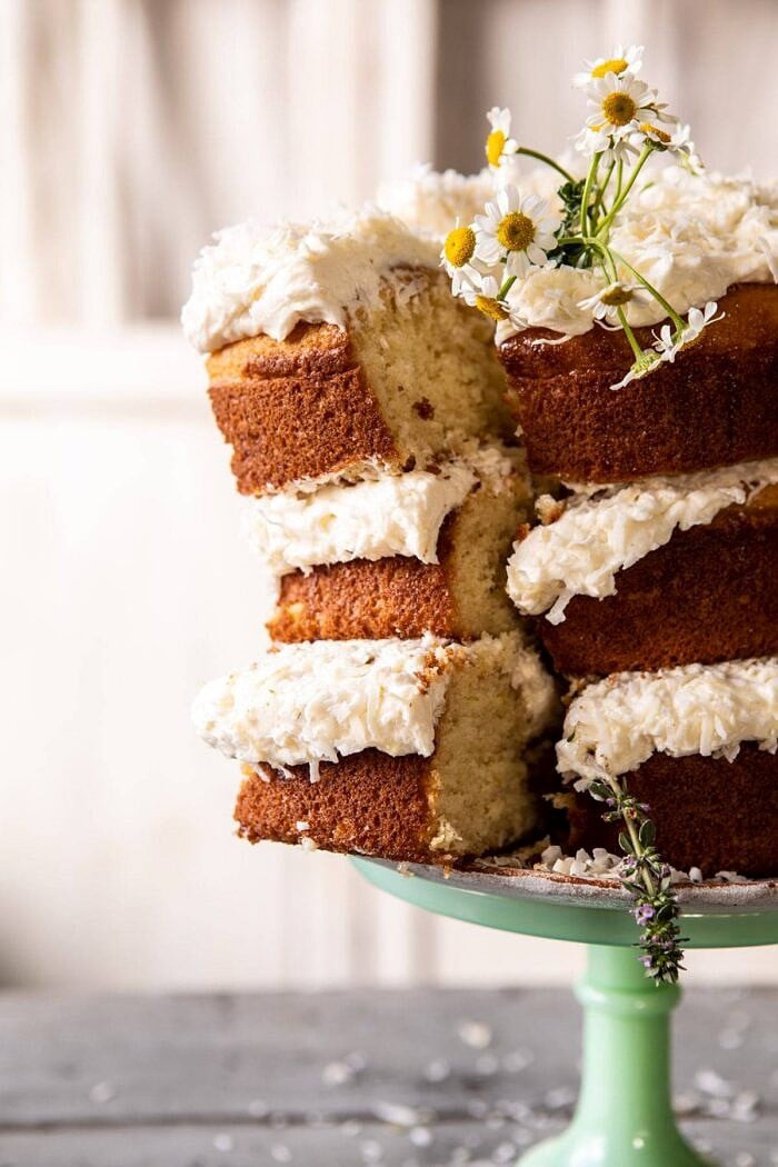 Lemon Coconut Naked Cake with Whipped Vanilla Buttercream | halfbakedharvest.com #coconutcake #springrecipes #easter #cake #layercake Lemon Coconut Naked Cake with Whipped Vanilla Buttercream with slice cut