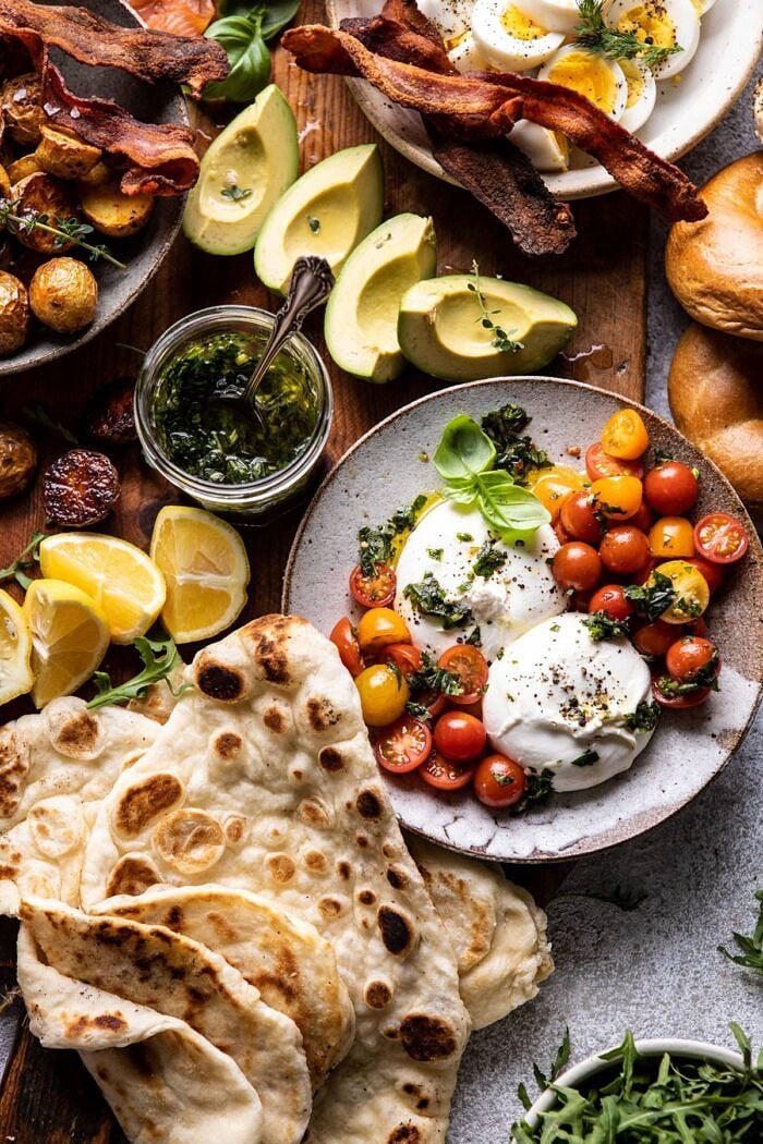 Ultimate Spring Brunch Board | halfbakedharvest.com #brunch #breakfast #potatoes #spring #summer #easter #mothersday overhead photo of Ultimate Spring Brunch Board, close up photo of burrata and tomatoes