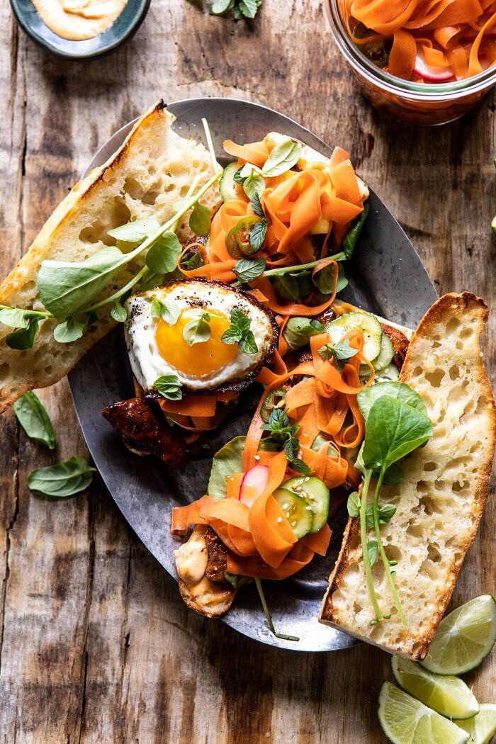 30 Minute Basil Chicken Banh Mi Sandwich | halfbakedharvest.com #easyrecipe #healthyrecipes #chicken #thai #Vietnamese overhead photo of 30 Minute Basil Chicken Banh Mi Sandwich with egg on top of sandwich