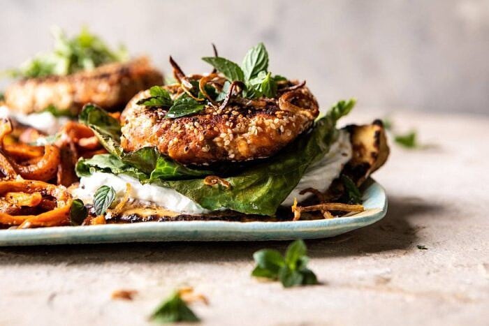 horizontal photo of Sesame Crusted Curried Salmon Burgers with Lemony Herbs 