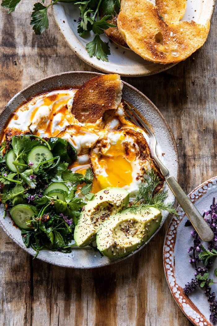 Turkish Eggs with Chile Butter and Whipped Feta | halfbakedharvest.com #breakfast #brunch #healthyrecipes #eggs #spring #summer overhead photo of Turkish Eggs with eggs broken in bowl