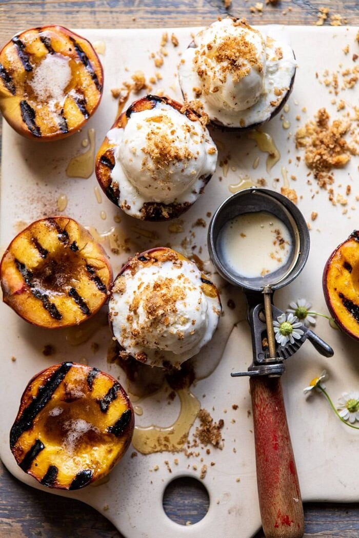 Browned Butter Grilled Peaches with Cinnamon Toast Brioche Crumbs | halfbakedharvest.com #summerrecipes #peaches #icecream #easyrecipes overhead close up photo of Browned Butter Grilled Peaches with Cinnamon Toast Brioche Crumbs on serving plate