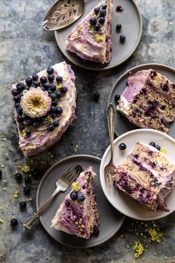 Bursting Blueberry Lemon Layer Cake | halfbakedharvest.com #bleberrycake #layercake #summerrecipes #dessert overhead photo of Bursting Blueberry Lemon Layer Cake slices