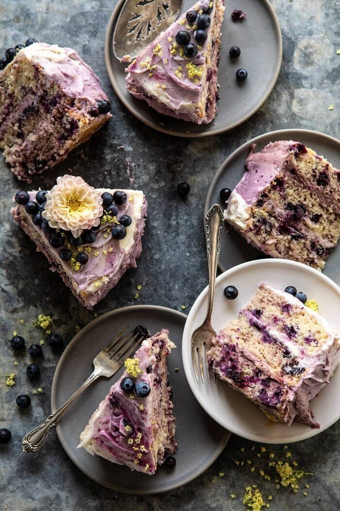 Bursting Blueberry Lemon Layer Cake | halfbakedharvest.com #bleberrycake #layercake #summerrecipes #dessert overhead photo of Bursting Blueberry Lemon Layer Cake slices