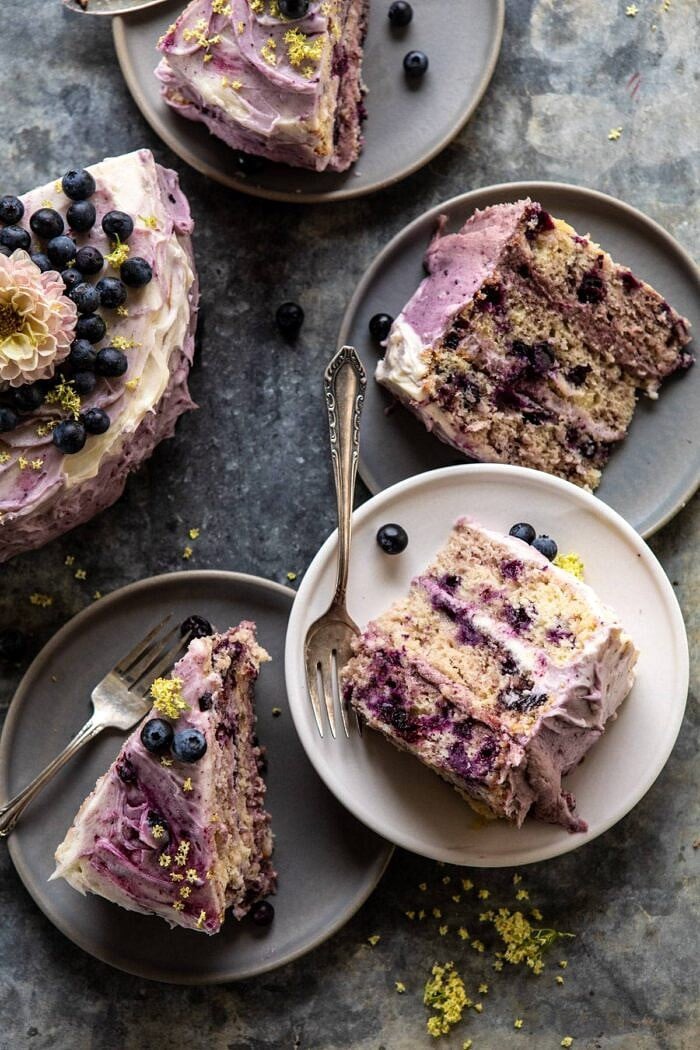 Bursting Blueberry Lemon Layer Cake | halfbakedharvest.com #bleberrycake #layercake #summerrecipes #dessert overhead close up photo of Bursting Blueberry Lemon Layer Cake slices
