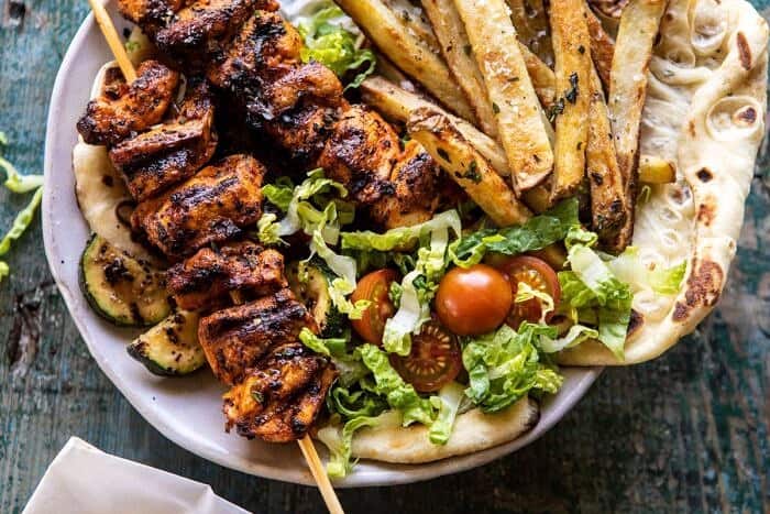 Chicken Souvlaki Bowls with Garlic Fries | halfbakedharvest.com #greek #healthyrecipes #dinner #summerrecipes horizontal photo of Chicken Souvlaki Bowls with Garlic Fries