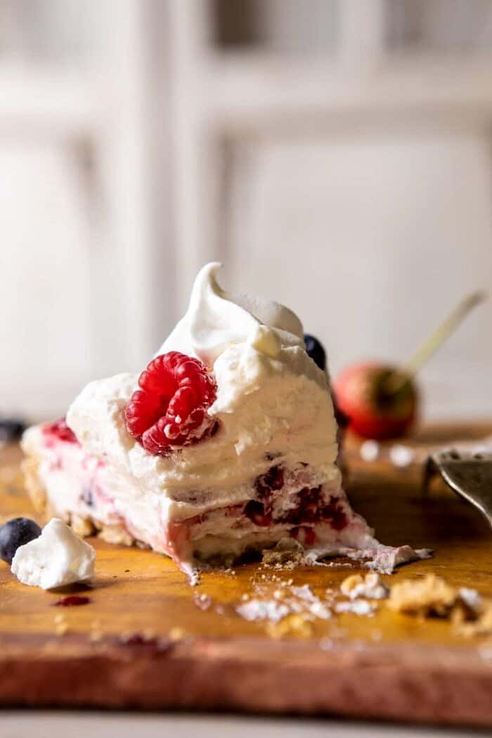 No-Bake Eton Mess Berry Cheesecake | halfbakedharvest.com #cheesecake #nonbake #easyrecipes #dessert #4thofjuly No-Bake Eton Mess Berry Cheesecake slice