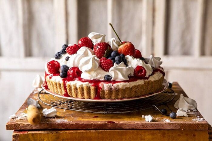 No-Bake Eton Mess Berry Cheesecake | halfbakedharvest.com #cheesecake #nonbake #easyrecipes #dessert #4thofjuly horizontal photo of No-Bake Eton Mess Berry Cheesecake