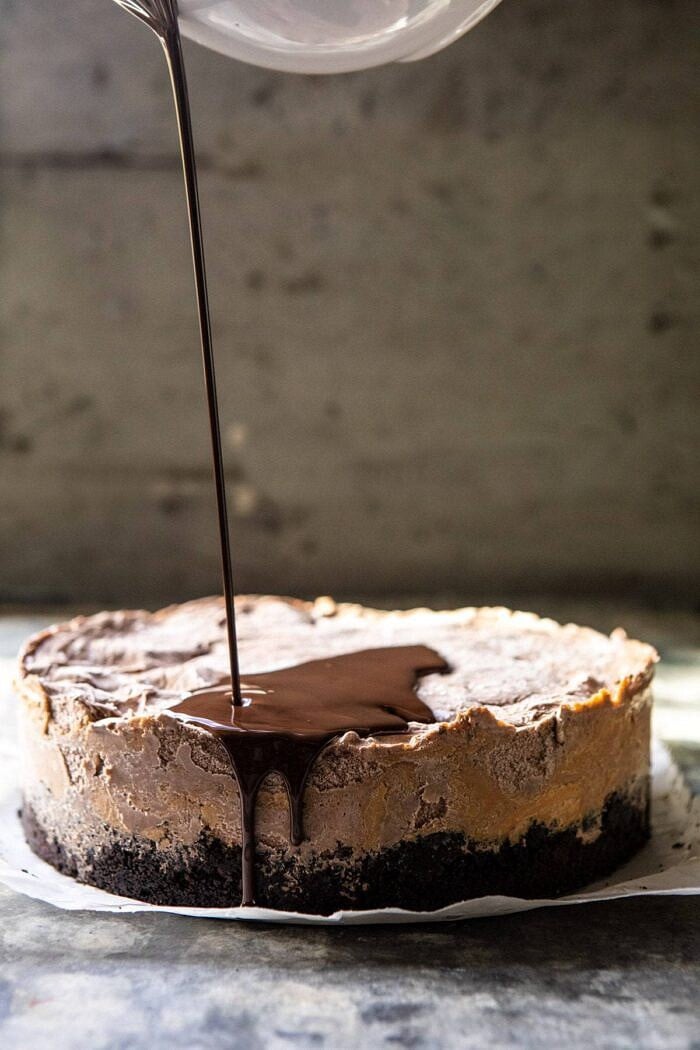 Nonnie's 6 Ingredient Chocolate Peanut Butter Ice Cream Cake | halfbakedharvest.com #icecream #easyrecipes #chocolate #peanutbutter #summer front on pour shot of Nonnie's 6 Ingredient Chocolate Peanut Butter Ice Cream Cake with chocolate sauce being drizzled on cake