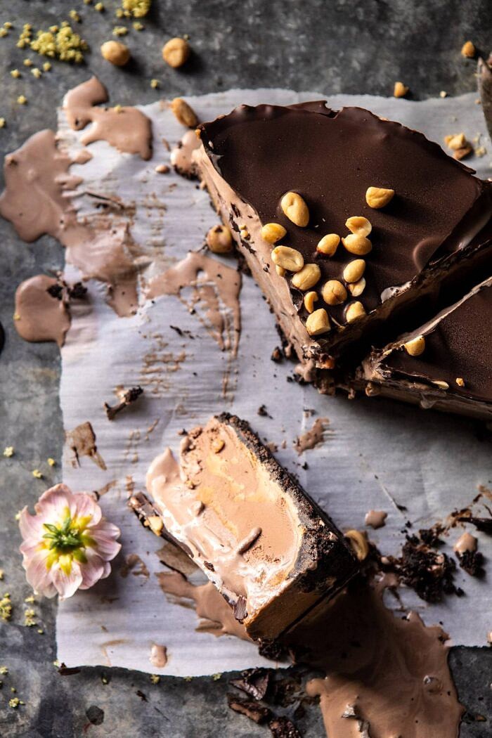 Nonnie's 6 Ingredient Chocolate Peanut Butter Ice Cream Cake | halfbakedharvest.com #icecream #easyrecipes #chocolate #peanutbutter #summer overhead photo of Nonnie's 6 Ingredient Chocolate Peanut Butter Ice Cream Cake slices on parchment papper