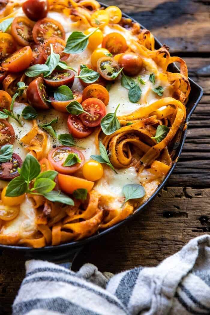 One Pot 30 Minute Creamy Tomato Basil Pasta Bake | halfbakedharvest.com #pasta #summerrecipes #onepot side angled close up photo of One Pot 30 Minute Creamy Tomato Basil Pasta Bake in skillet