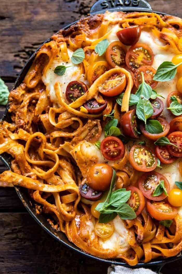One Pot 30 Minute Creamy Tomato Basil Pasta Bake | halfbakedharvest.com #pasta #summerrecipes #onepot overhead close up photo of One Pot 30 Minute Creamy Tomato Basil Pasta Bake with serving of pasta removed
