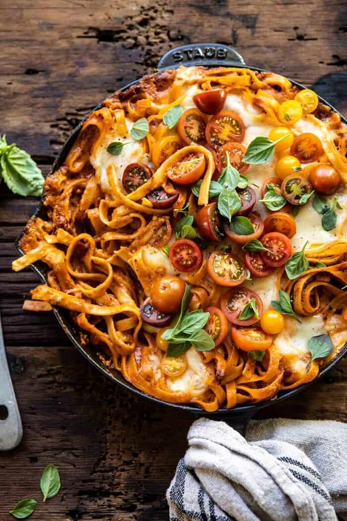 One Pot 30 Minute Creamy Tomato Basil Pasta Bake | halfbakedharvest.com #pasta #summerrecipes #onepot One Pot 30 Minute Creamy Tomato Basil Pasta Bake with serving of pasta removed from skillet