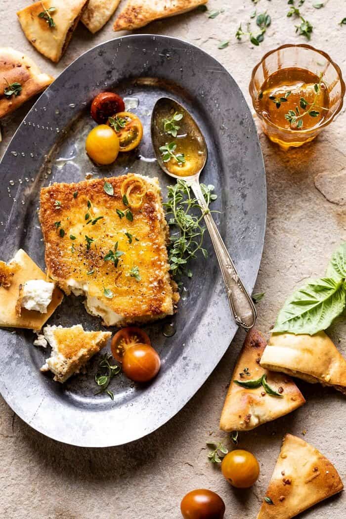 Pan-Fried Feta with Peppered Honey | halfbakedharvest.com #appetizers #easyrecipes #summerrecipes overhead photo of Pan-Fried Feta broken into pieces with Peppered Honey