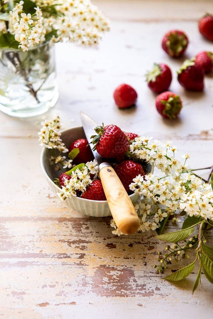 fresh strawberries in bowl with lilacs 