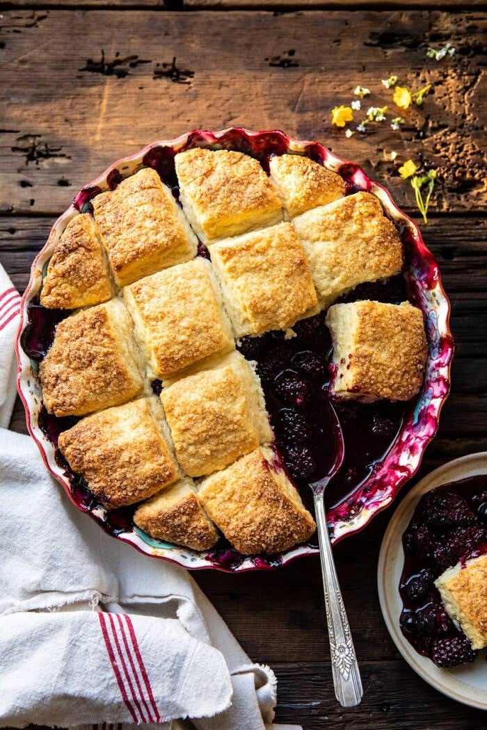 overhead photo of Blackberry Lavender Cobbler with spoon in baking dish
