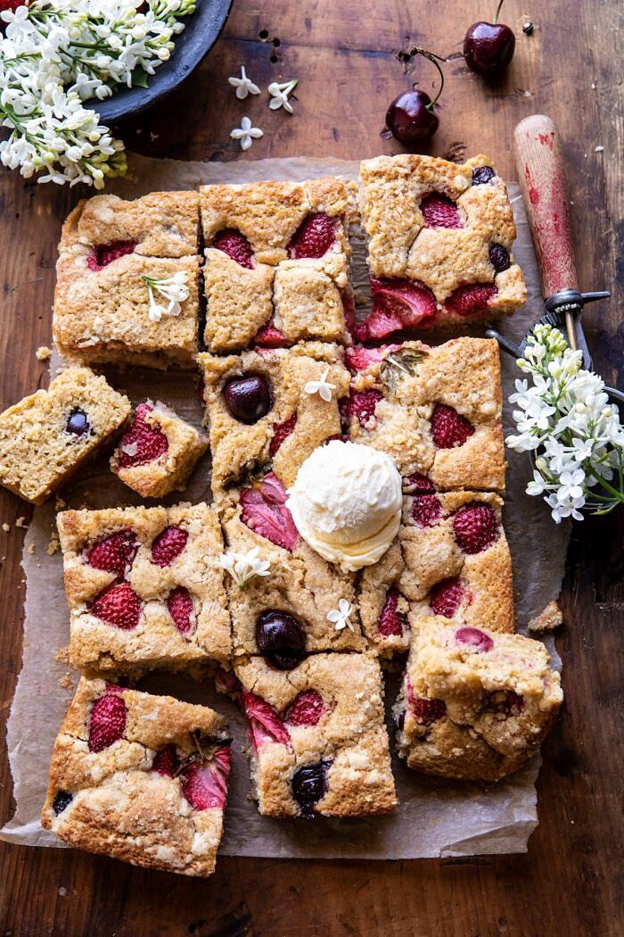 overhead photo of Cherry Strawberry Streusel Cake with cake pieces cut and ice cream on cake