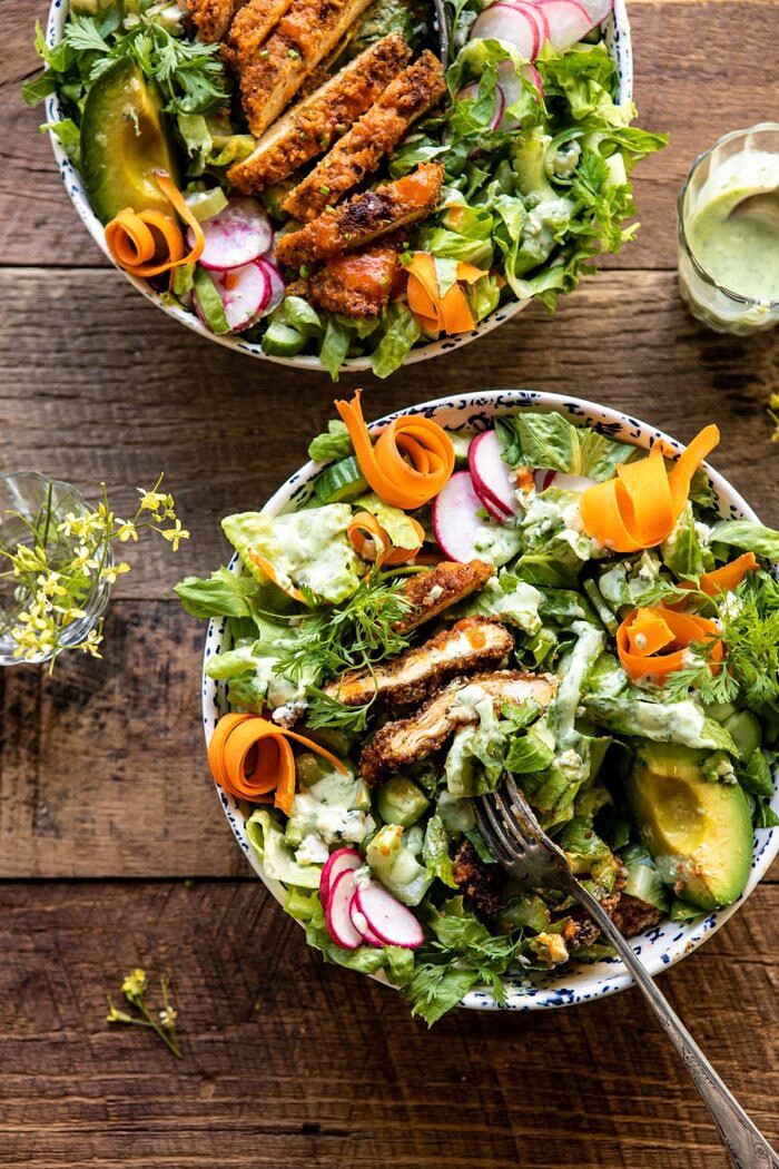 Crispy Buffalo Ranch Chicken Salad with Goddess Dressing | halfbakedharvest.com #buffalochicken #salad #healthy #dinner overhead photo of Crispy Buffalo Ranch Chicken Salad with Goddess Dressing and fork in salad to showing the inside of the chicken