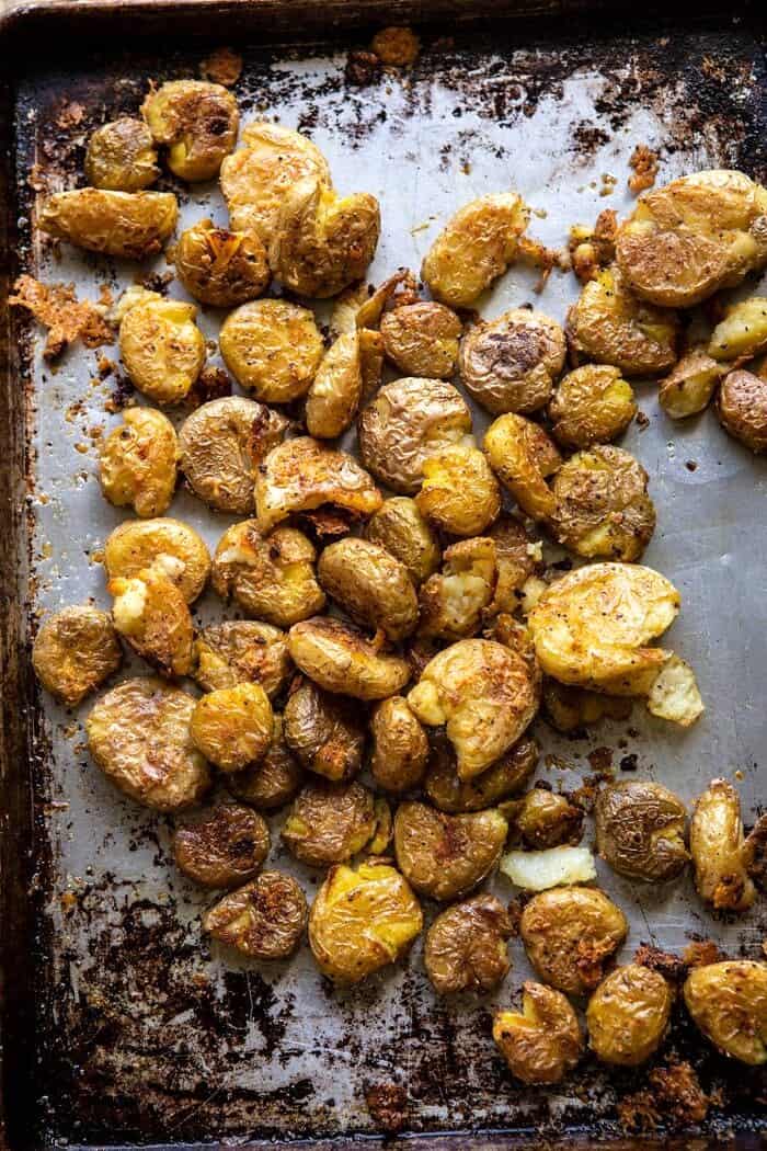 Crispy Salt and Vinegar Smashed Potatoes | halfbakedharvest.com #potatoes #instantpot #easyrecipes #sidedish overhead photo of Crispy Salt and Vinegar Smashed Potatoes on baking sheet after roasting