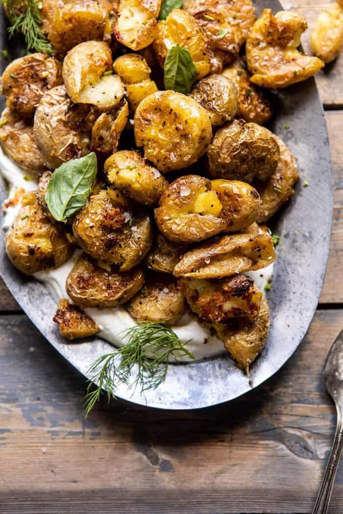 Crispy Salt and Vinegar Smashed Potatoes | halfbakedharvest.com #potatoes #instantpot #easyrecipes #sidedish overhead close up photo of Crispy Salt and Vinegar Smashed Potatoes on platter