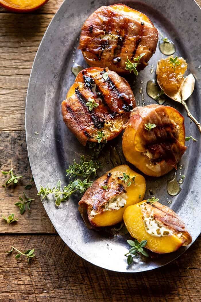 Prosciutto Goat Cheese Stuffed Peaches with Thyme Honey | halfbakedharvest.com #peaches #appetizer #goatcheese overhead close up photo of Prosciutto Goat Cheese Stuffed Peaches with Thyme Honey