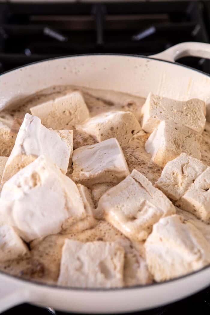 Better Than Mom's Brown Butter Rice Krispie Treats | halfbakedharvest.com #ricekrispietreats #healthier #easy #backtoschool #dessert photo of marshmallows melting into browned butter on stove-top