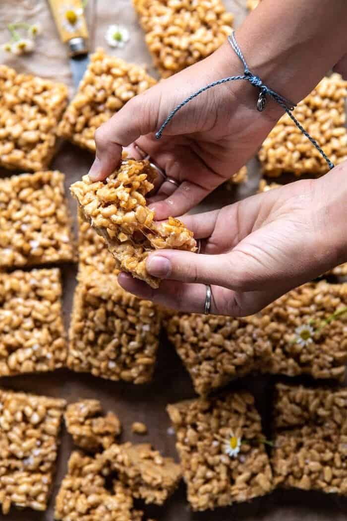 Better Than Mom's Brown Butter Rice Krispie Treats | halfbakedharvest.com #ricekrispietreats #healthier #easy #backtoschool #dessert overhead photo of Better Than Mom's Brown Butter Rice Krispie Treats being pulled apart to show their sticky marshmallow center