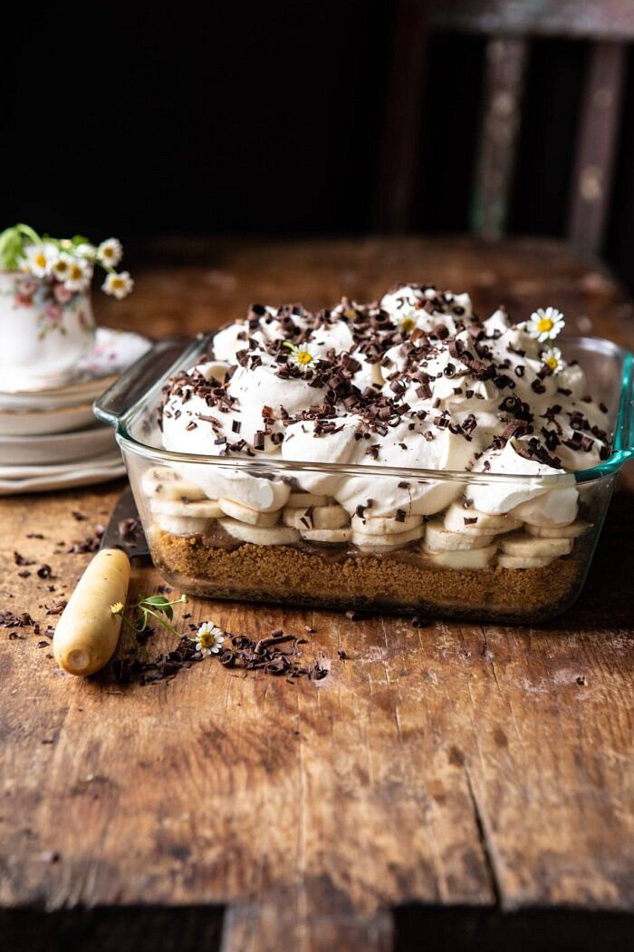 Healthier Banoffee Pie | halfbakedharvets.com #dessert #vegan #easyrecipes #healthy #chocolate #banana side angled photo of Healthier Banoffee Pie with plates on surface and chair in background