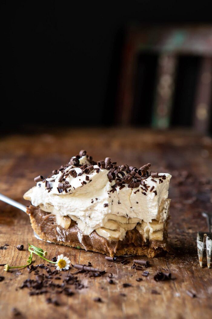 Healthier Banoffee Pie | halfbakedharvets.com #dessert #vegan #easyrecipes #healthy #chocolate #banana side angled photo of Healthier Banoffee Pie slice with bite taken out of pie