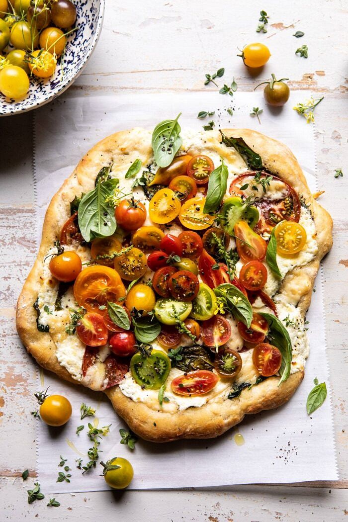 Herbed Butter Heirloom Tomato Pizza | halfbakedharvest.com #pizza #easyrecipe #tomatoes overhead photo of Herbed Butter Heirloom Tomato Pizza
