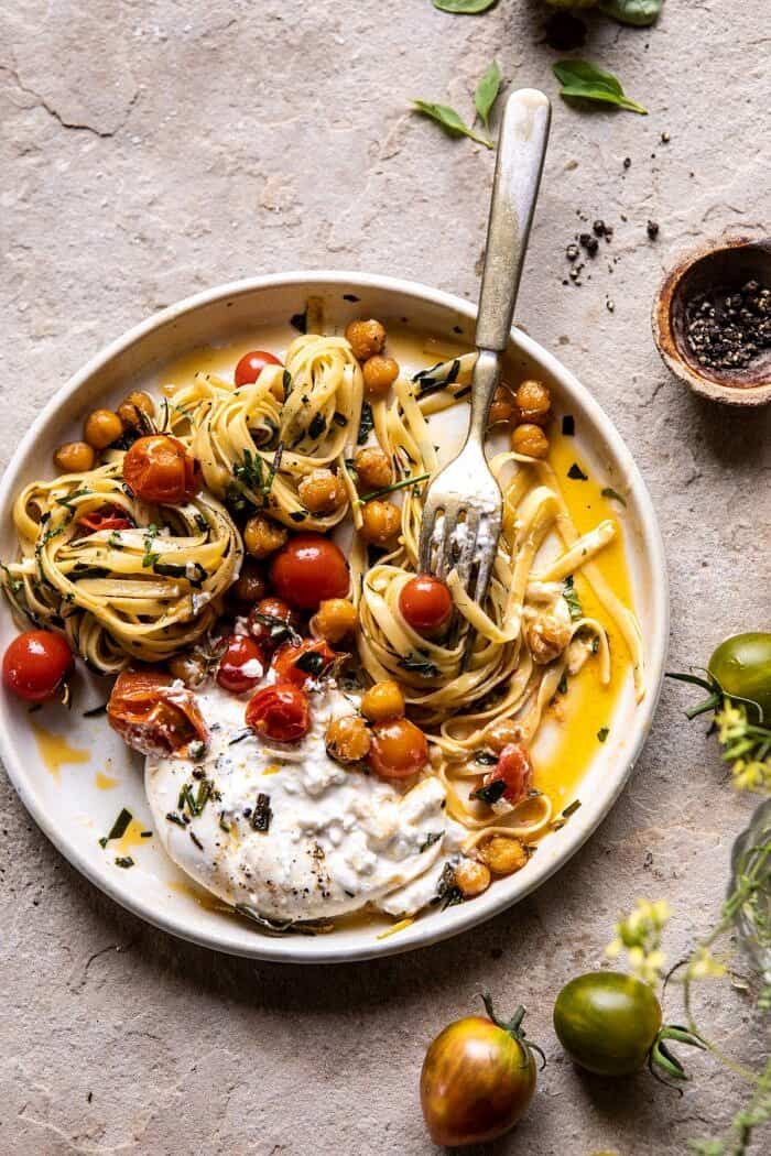 overhead photo Jammy Cherry Tomato Pasta with Crisp Lemon Rosemary Chickpeas with fork on plate twirling the pasta