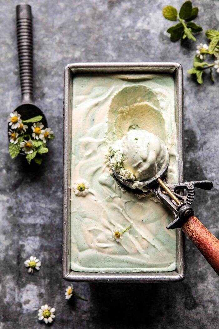 No Churn Minted White Chocolate Swirled Ice Cream | halfbakedharvest.com #icecream #easyrecipes #dessert #nochurnicecream overhead photo of No Churn Minted White Chocolate Swirled Ice Cream with ic cream scoop in ice cream