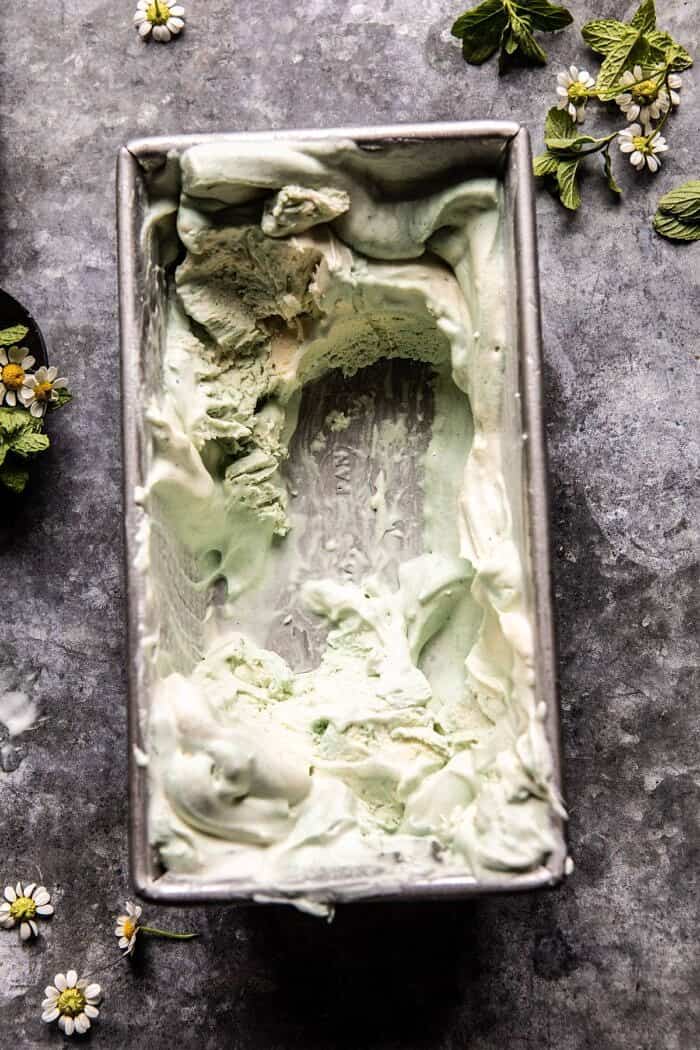 No Churn Minted White Chocolate Swirled Ice Cream | halfbakedharvest.com #icecream #easyrecipes #dessert #nochurnicecream overhead photo of No Churn Minted White Chocolate Swirled Ice Cream with most of the ice cream removed from container