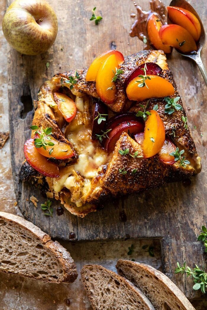 overhead close up photo of Pastry Wrapped Baked Brie with Thyme Butter Roasted Plums