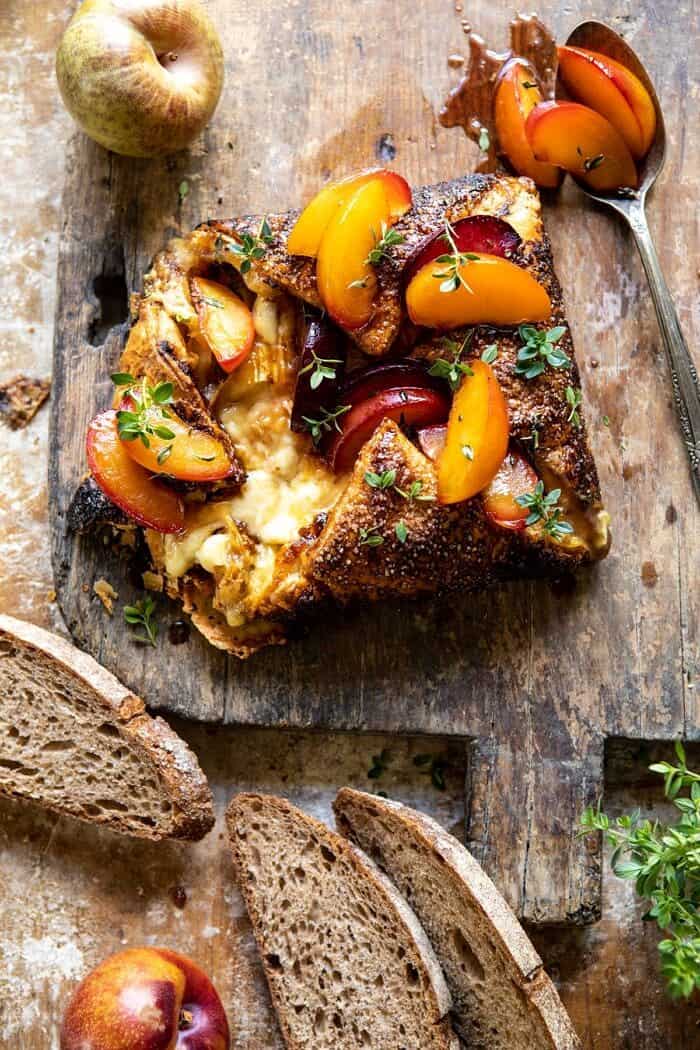 overhead photo of Pastry Wrapped Baked Brie with Thyme Butter Roasted Plums