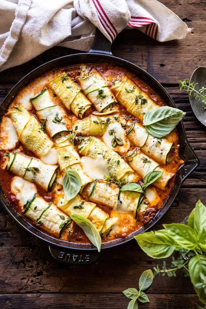 Spicy Pesto and Cheese Stuffed Zucchini Involtini | halfbakedharvest.com #zucchini #cheese #Italian #easyrecipes overhead photo of Spicy Pesto and Cheese Stuffed Zucchini Involtini after baking in skillet