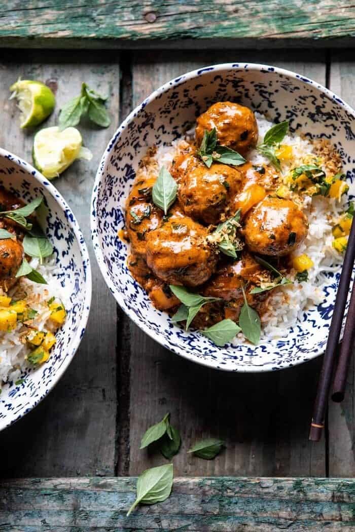 Weeknight 30 Minute Coconut Curry Chicken Meatballs | halfbakedharvest.com #curry #meatballs #healthy overhead close up photo of Weeknight 30 Minute Coconut Curry Chicken Meatballs in bowls with rice