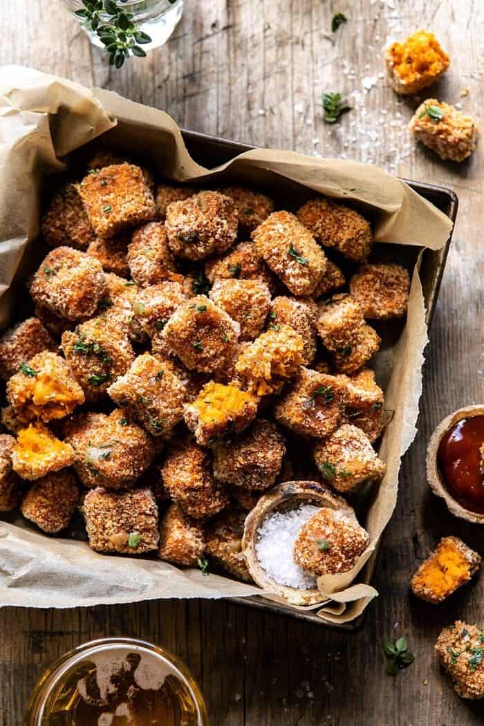 Baked Sweet Potato Parmesan Tater Tots | halfbakedharvest.com #sweetpotatoes #healthy #easyrecipes #gameday #tatertots overhead close up photo of Baked Sweet Potato Parmesan Tater Tots with tot broken in half