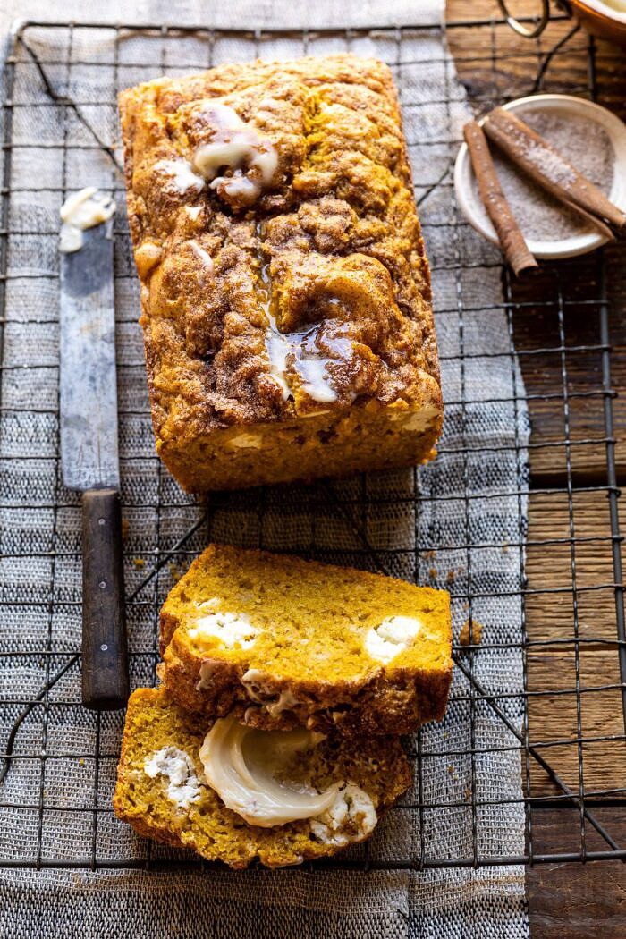 Cream Cheese Swirled Pumpkin Bread with Salted Maple Butter | halfbakedharvest.com #easyrecipes #pumpkinbread #pumpkin #fallrecipes overhead photo of Cream Cheese Swirled Pumpkin Bread with 2 slices of bread cut and cinnamon sugar in photo