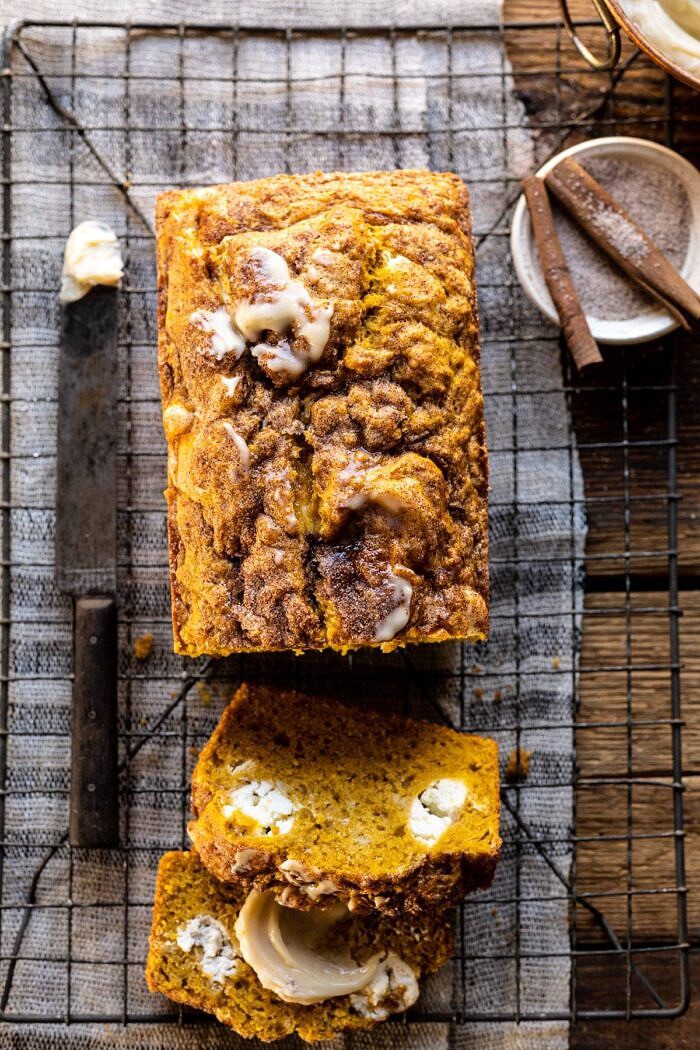 Cream Cheese Swirled Pumpkin Bread with Salted Maple Butter | halfbakedharvest.com #easyrecipes #pumpkinbread #pumpkin #fallrecipes overhead close up photo of Cream Cheese Swirled Pumpkin Bread with 2 slices of bread cut