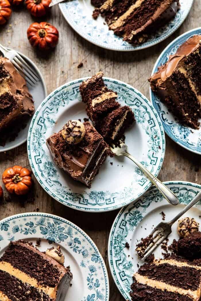 Pumpkin Patch Chocolate Peanut Butter Cake | halfbakedharvest.com #chocolatepeanutbutter #chocolatecake #peanutbutter #halloween overhead photo of Pumpkin Patch Chocolate Peanut Butter Cake slices on plates