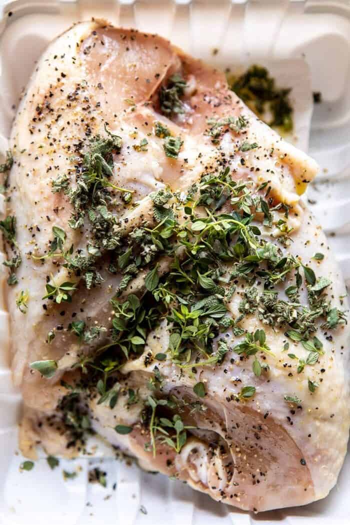 Slow Cooker French Wine and Mustard Chicken | halfbakedharvest.com #slowcooker #crockpot #instantpot #chicken overhead photo of raw chicken breast before cooking with herbs